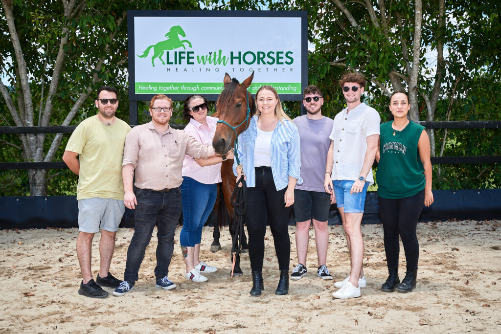 Equine therapy session at Life with Horses in South East Queensland, featuring a retired racehorse providing emotional support and comfort to participants.